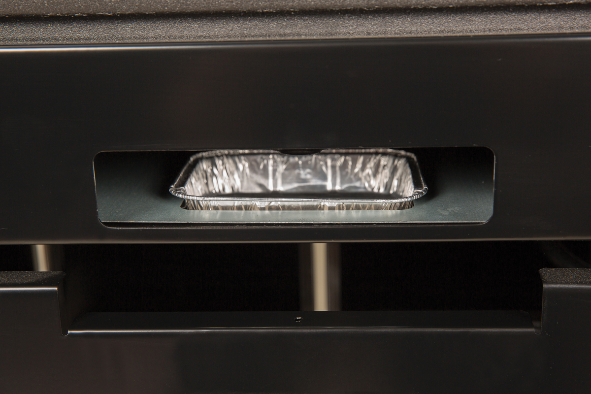 Foil drip pan placed in a grill drip-tray opening