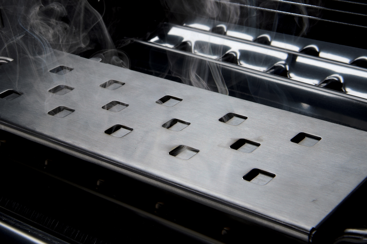 Premium stainless steel smoker box smoking beneath the cooking grids