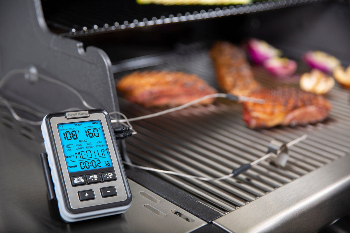 Side-table thermometer connected to food probes at the grill