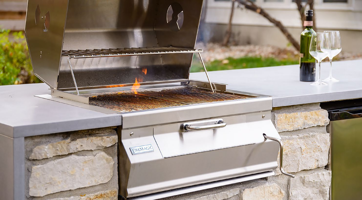 Fire Magic 24″ Built-In Charcoal Grill in an outdoor cooking setting