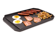 Food arranged on a cast iron plancha