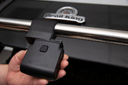 Hand positioning a grill light on a separate grill handle