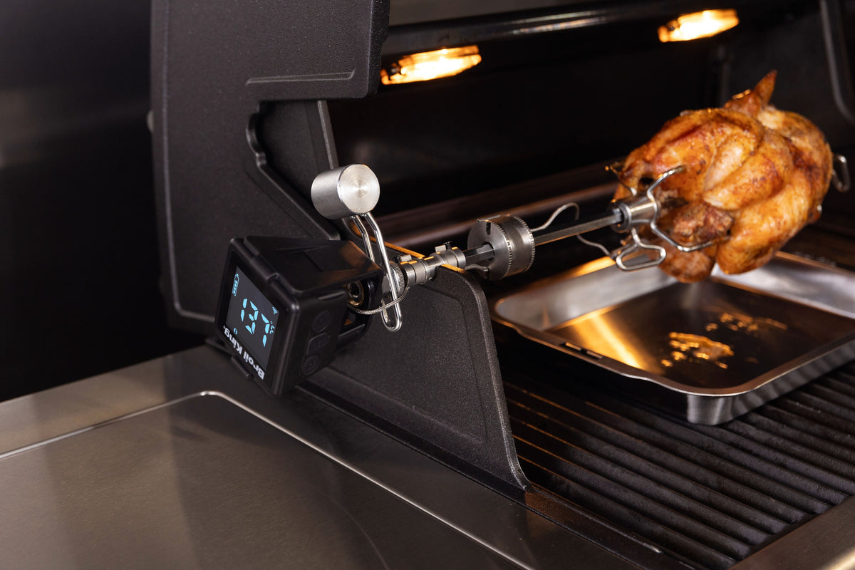 iQue thermometer mounted beside a roast on a separate grill rotisserie
