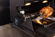 iQue thermometer mounted beside a roast on a separate grill rotisserie