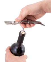 Wine and bottle opener being used to remove a cork