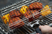 Detachable-handle grill basket holding stuffed vegetables