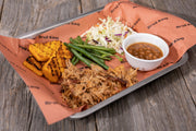 Cooked barbecue served on a butcher-paper-lined tray