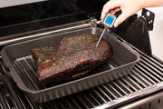 Thermometer checking a roast in a cast iron multi roaster