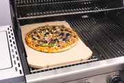 Pizza cooking on a rectangular stone on the grill