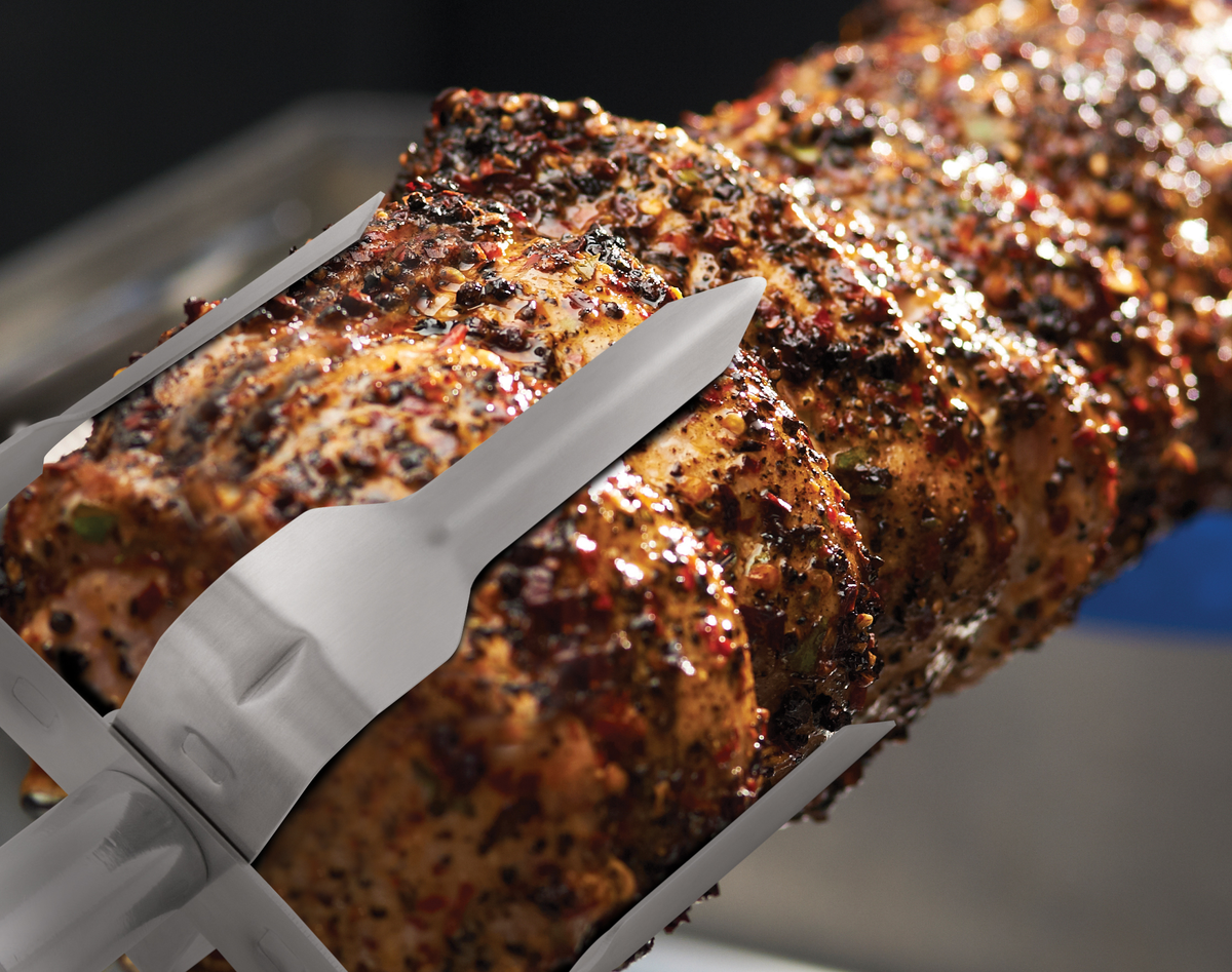Mega rotisserie forks holding a roast on a spit