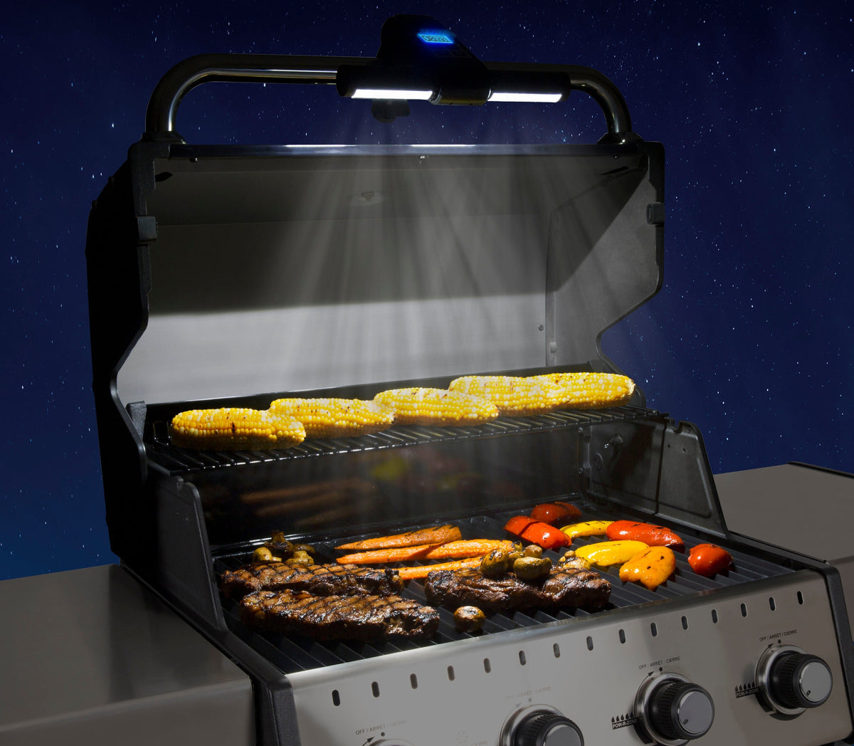 Handle-mounted light illuminating the grill cooking surface