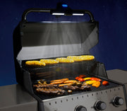 Handle-mounted light illuminating the grill cooking surface