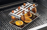 Chicken wings suspended over a collection pan on a wing rack