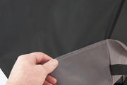 Hand lifting the fabric edge of a Select grill cover