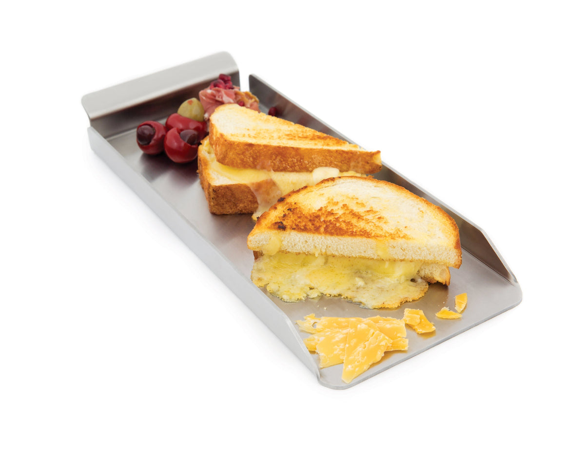 Sandwiches and vegetables on a narrow stainless steel griddle