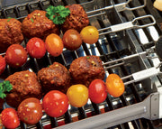 Meatballs and tomatoes on skewers in the narrow kebab rack