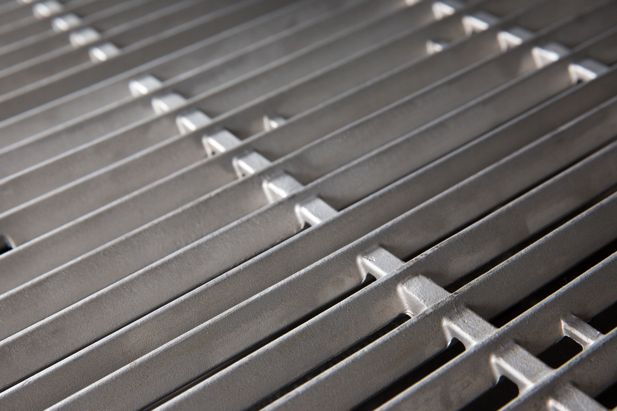 Cast stainless steel cooking grids installed in a separate grill