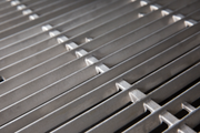 Cast stainless steel cooking grids installed in a separate grill