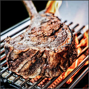Steak cooking on an infrared side-burner grate