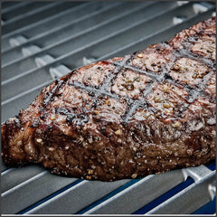 Steak on cast stainless steel cooking grids