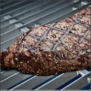 Steak on cast stainless steel cooking grids