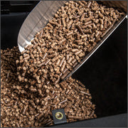 Wood pellets being poured into the hopper