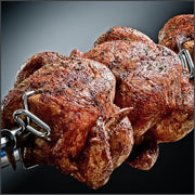 Chickens secured on a rotisserie spit
