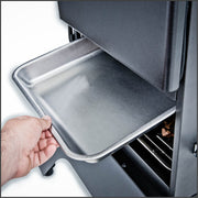 Stainless steel water pan being placed in the cabinet smoker