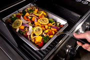 Vegetables being stirred in a stainless steel shelf insert wok