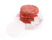 Burger press papers separating stacked raw burger patties