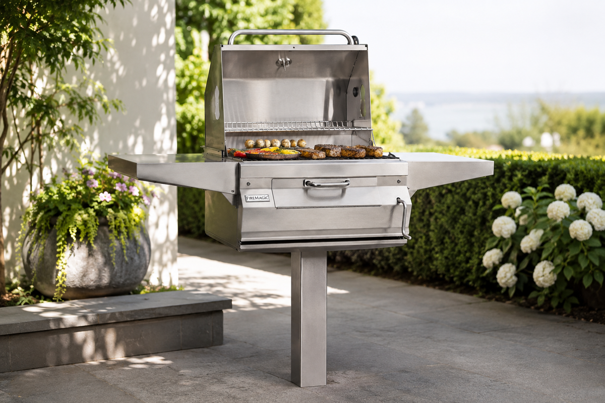 Fire Magic 24″ In-Ground Post Charcoal Grill in an outdoor cooking setting