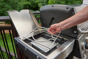 Hand positioning a wok ring over a gas side burner