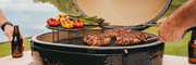 Primo XL with steaks and vegetables on the cooking grates