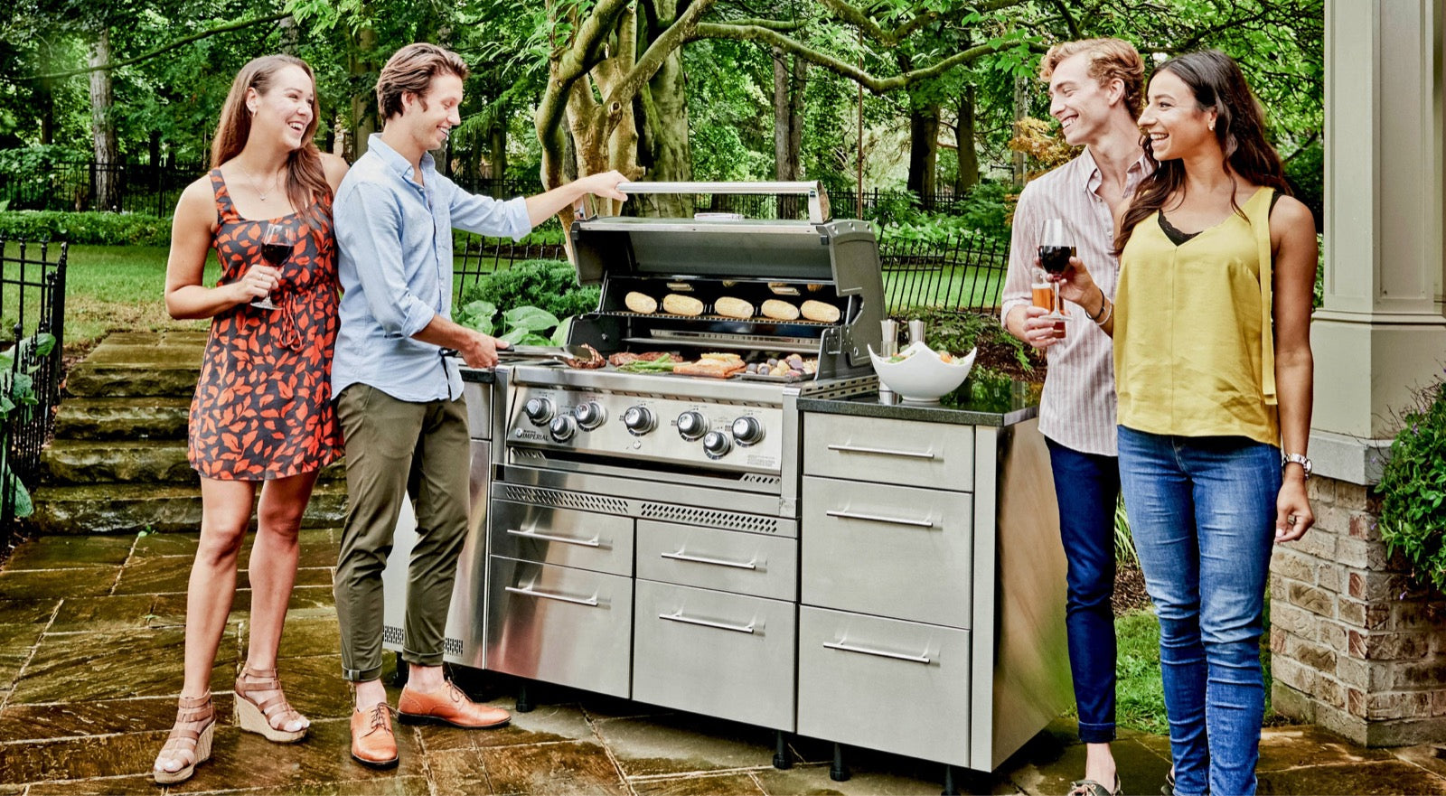 Broil King outdoor kitchen in use on a patio
