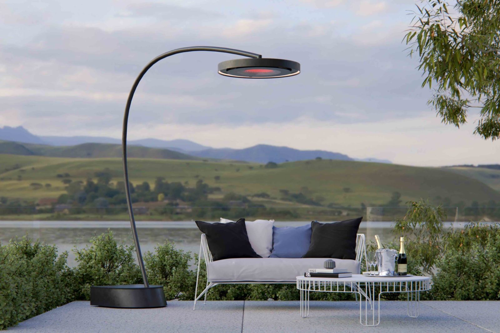 Bromic Eclipse freestanding electric heater beside an outdoor lounge overlooking the countryside